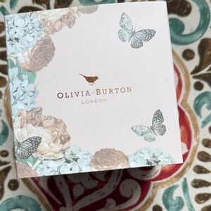 Women’s gold watch with floral face.